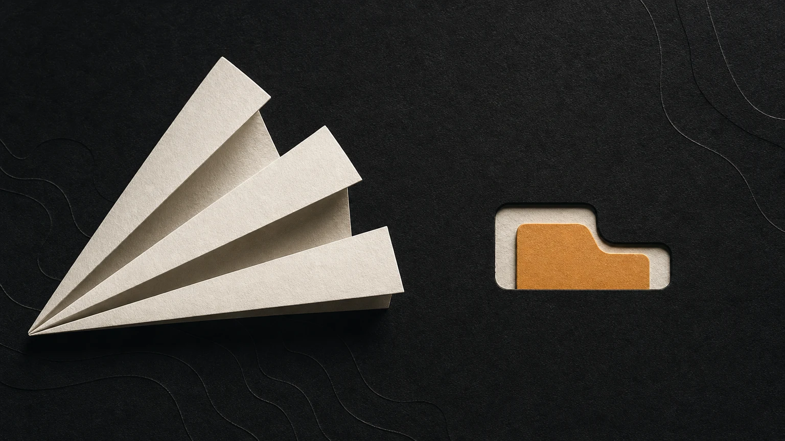 An ivory paper fan sits beside a single amber tab fitted into a matching recess.